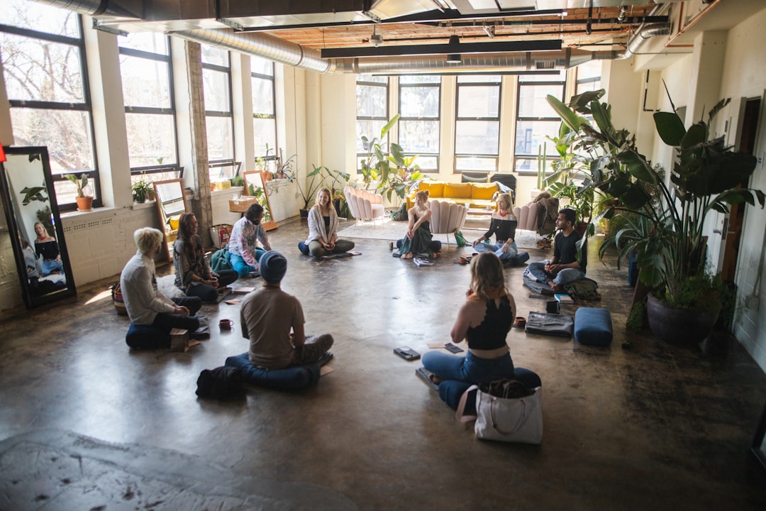 services-02 a-group-of-people-sitting-in-a-circle-in-a-room-ciqbtwuggbi